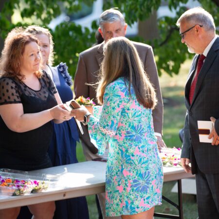 a group of people standing around a table
