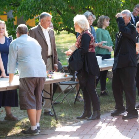 a group of people standing around tables
