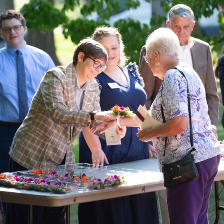 a group of people standing around a table