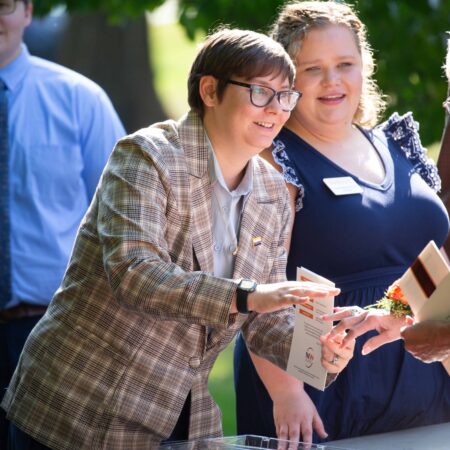 a person handing a piece of paper to a person
