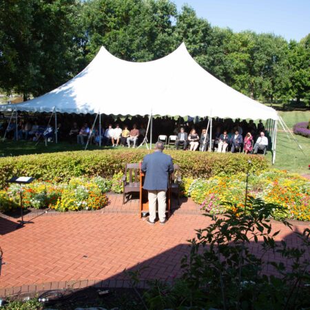 a person standing in front of a white tent