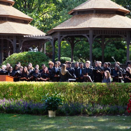 a group of people performing in a garden