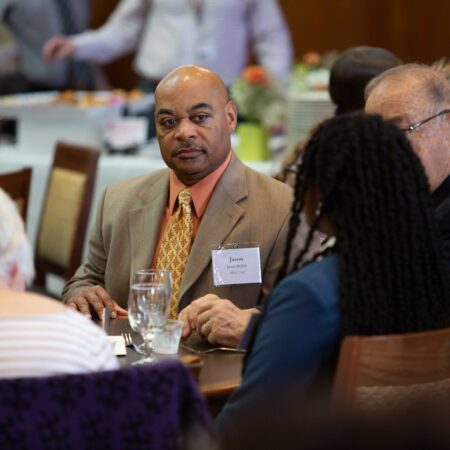 a person in a suit sitting at a table