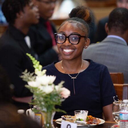 a person smiling at a table