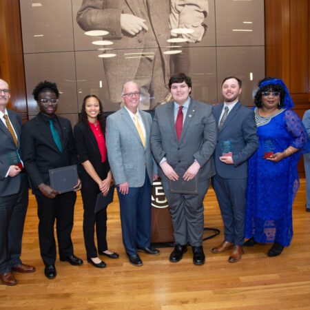 a group of people standing in front of a picture
