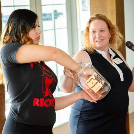 a person holding a glass jar with a person in the background