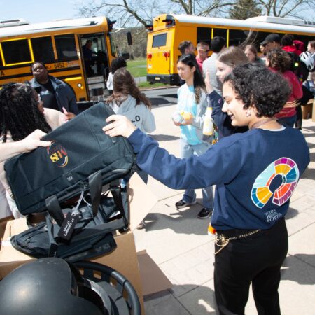a group of people outside with a backpack