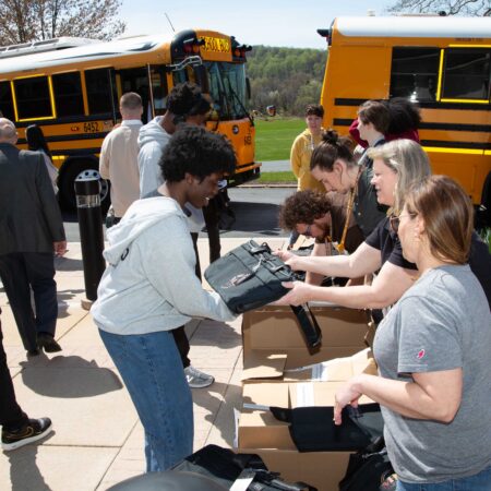 a group of people receiving a bag