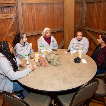 a group of people sitting around a round table