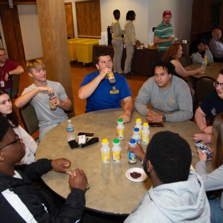 a group of people sitting around a table