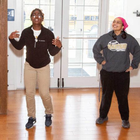 a couple of women dancing in a room