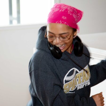 a person wearing headphones and talking on a phone