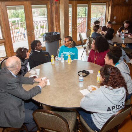 a group of people sitting around a round table