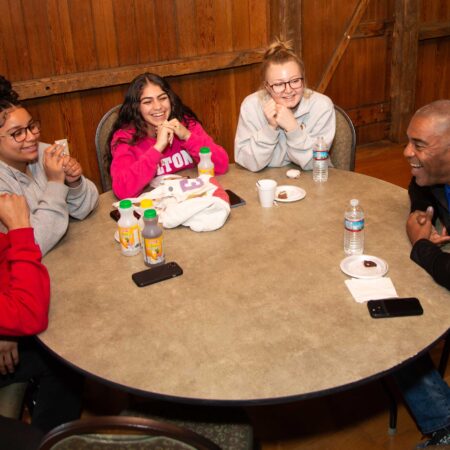a group of people sitting at a round table