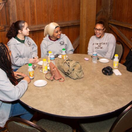 a group of people sitting around a round table