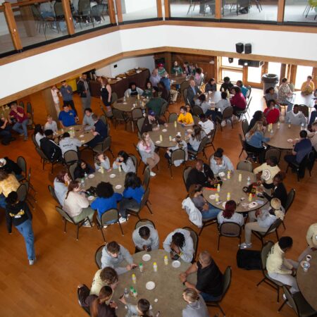 a group of people sitting at tables in a room