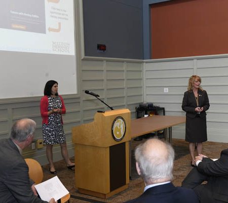 a group of people standing in front of a podium