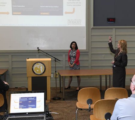 a person standing in front of a projection screen
