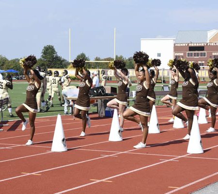 a group of cheerleaders on a track