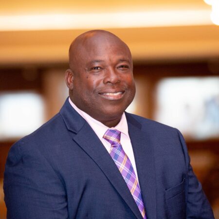 a person in a suit smiling
