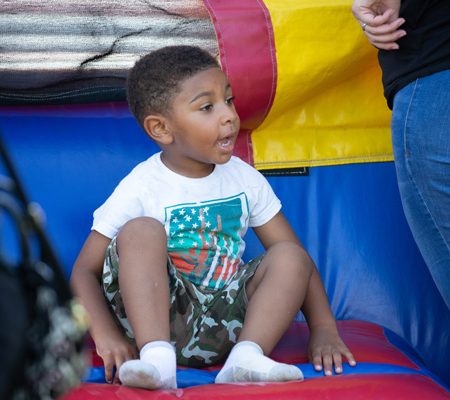 a child sitting on a bouncy castle