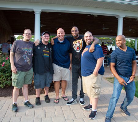 a group of men posing for a photo