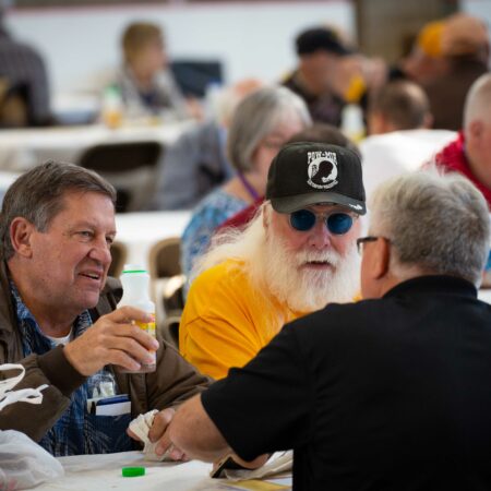 a group of men sitting at tables