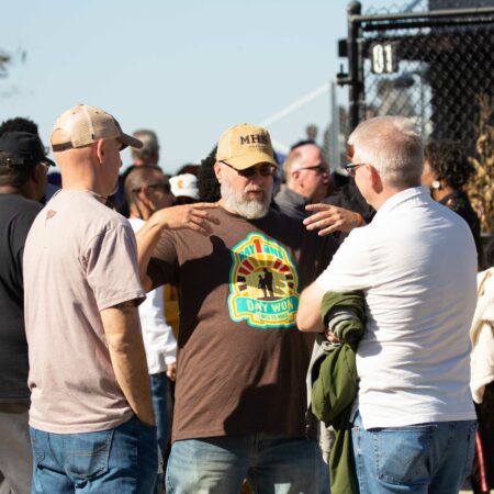 a group of people standing around each other