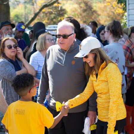 people shaking hands with a child