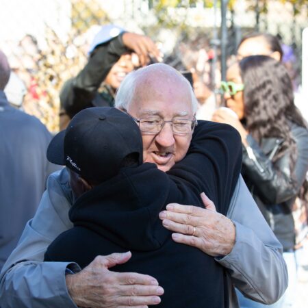 a person hugging another person