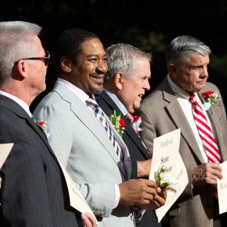 a group of men holding papers