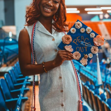 a person holding a graduation cap