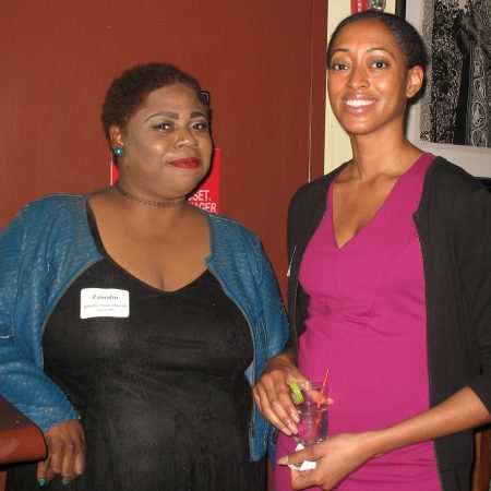 a couple of women standing together