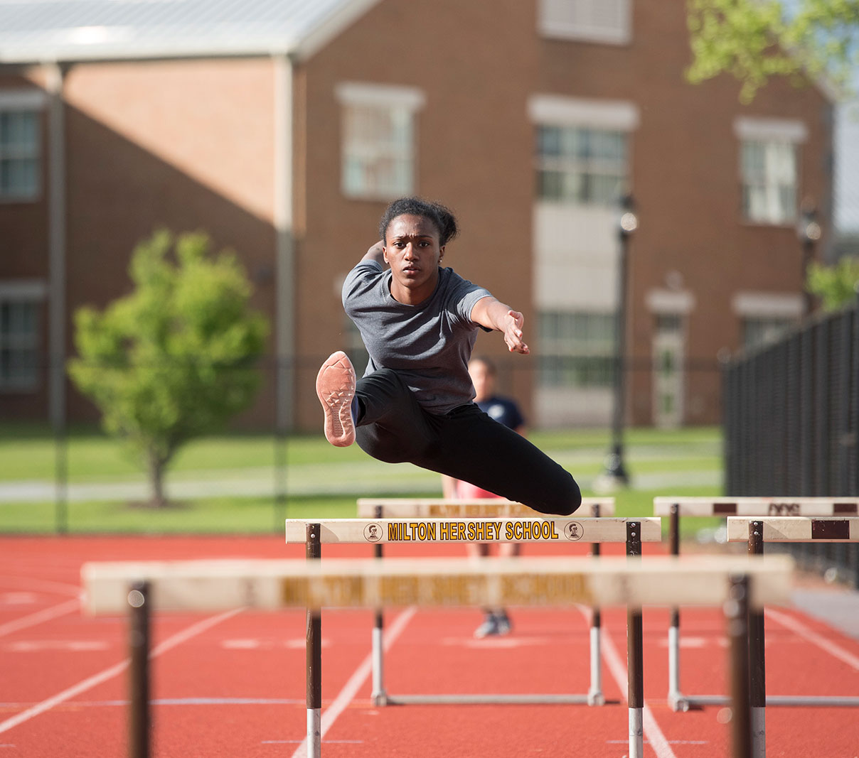 MHS athlete jumping hurdles