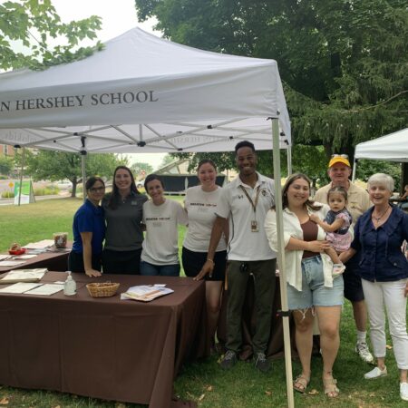 a group of people standing under a tent