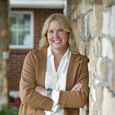 Milton Hershey School Alumni Association President Mary Pratt-Lauchle poses for a photo outside Purcell Friendship Hall.